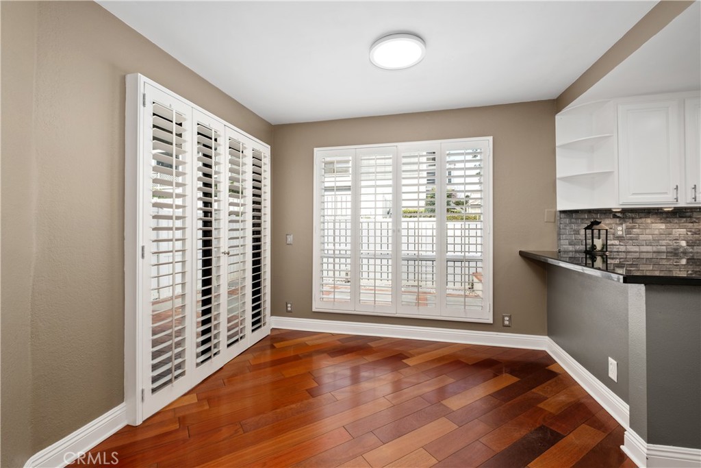 7 Oak Spring Lane, Unit 319 Aliso Viejo, CA 92656 - Photo 6 of 37 a view of an empty room with a window and wooden floor
