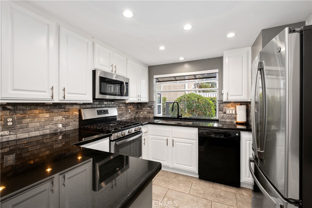 7 Oak Spring Lane, Unit 319 Aliso Viejo, CA 92656 - Photo 10 of 37 a kitchen with a sink stainless steel appliances and cabinets