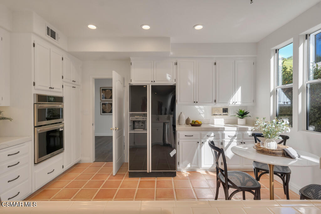 3842 Timberridge Road Moorpark, CA 93021 - Photo 17 of 75 a living room with stainless steel appliances kitchen island granite countertop a dining table chairs and a refrigerator