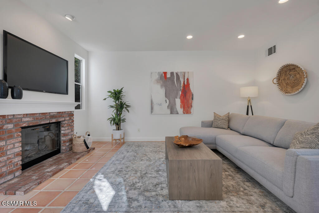 3842 Timberridge Road Moorpark, CA 93021 - Photo 23 of 75 a living room with furniture a fireplace and a flat screen tv