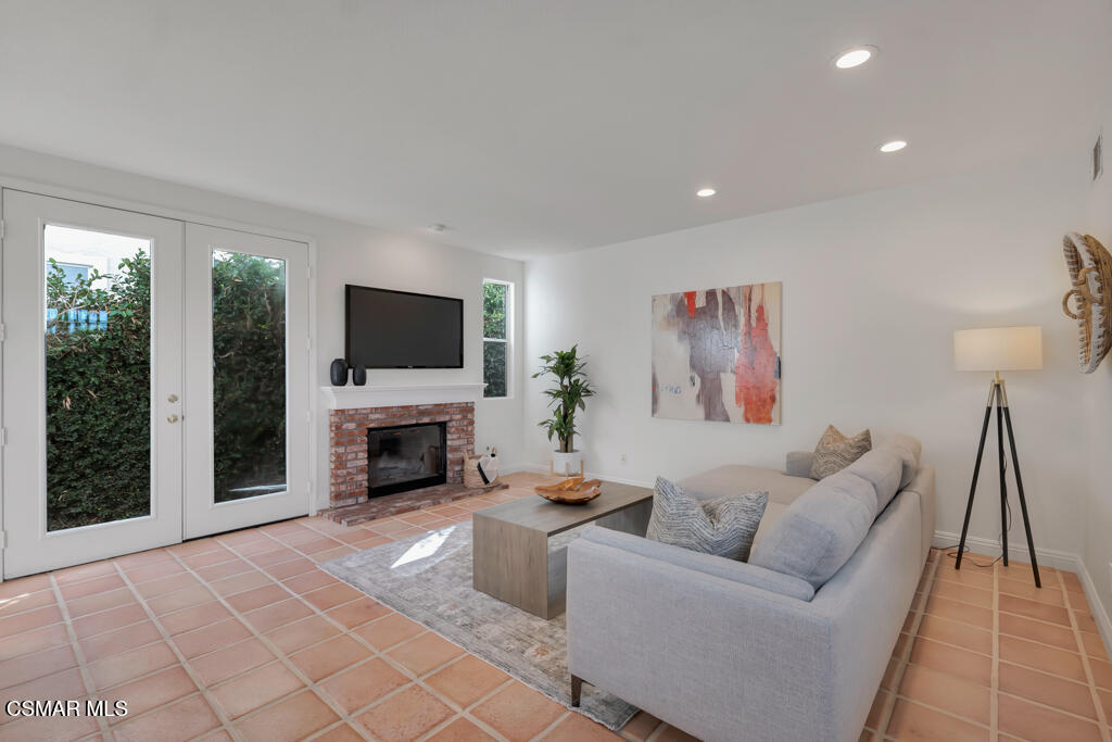 3842 Timberridge Road Moorpark, CA 93021 - Photo 25 of 75 a living room with furniture a fireplace and a flat screen tv