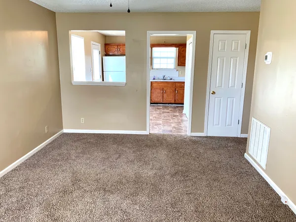 an empty room with windows and closet