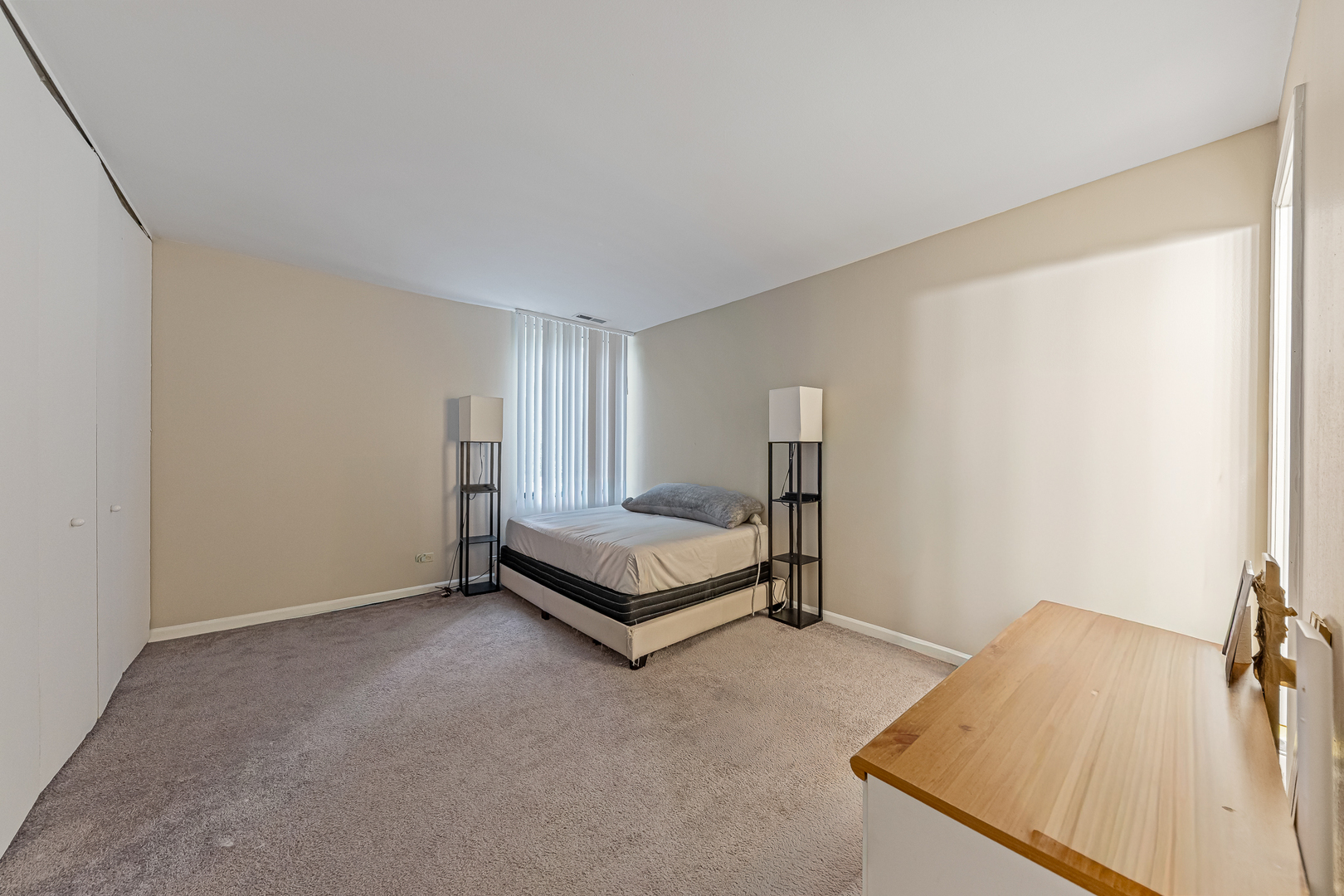 6015 Forest View Road, Unit 2A Lisle, IL 60532 - Photo 8 of 12 a spacious bedroom with a bed and a table