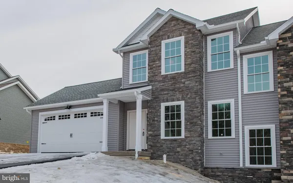 a front view of a house with parking space