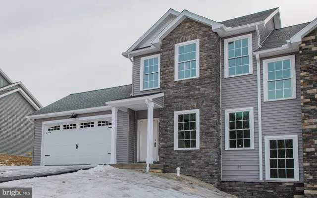 a front view of a house with parking space