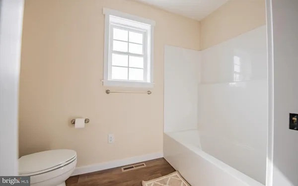 a bathroom with a bathtub and toilet