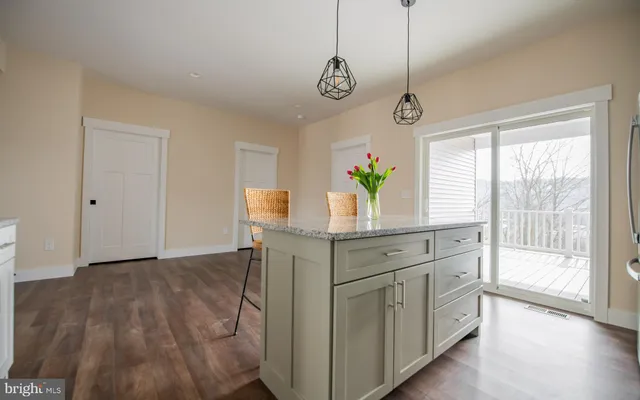 a kitchen with stainless steel appliances granite countertop a stove a sink and a window