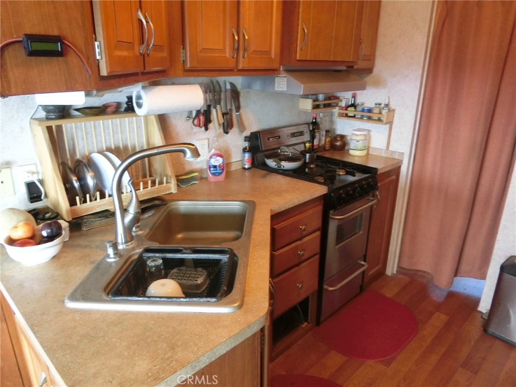 864 Watertrough Road Clearlake Oaks, CA 95423 - Photo 37 of 58 a kitchen with a sink a stove and cabinets