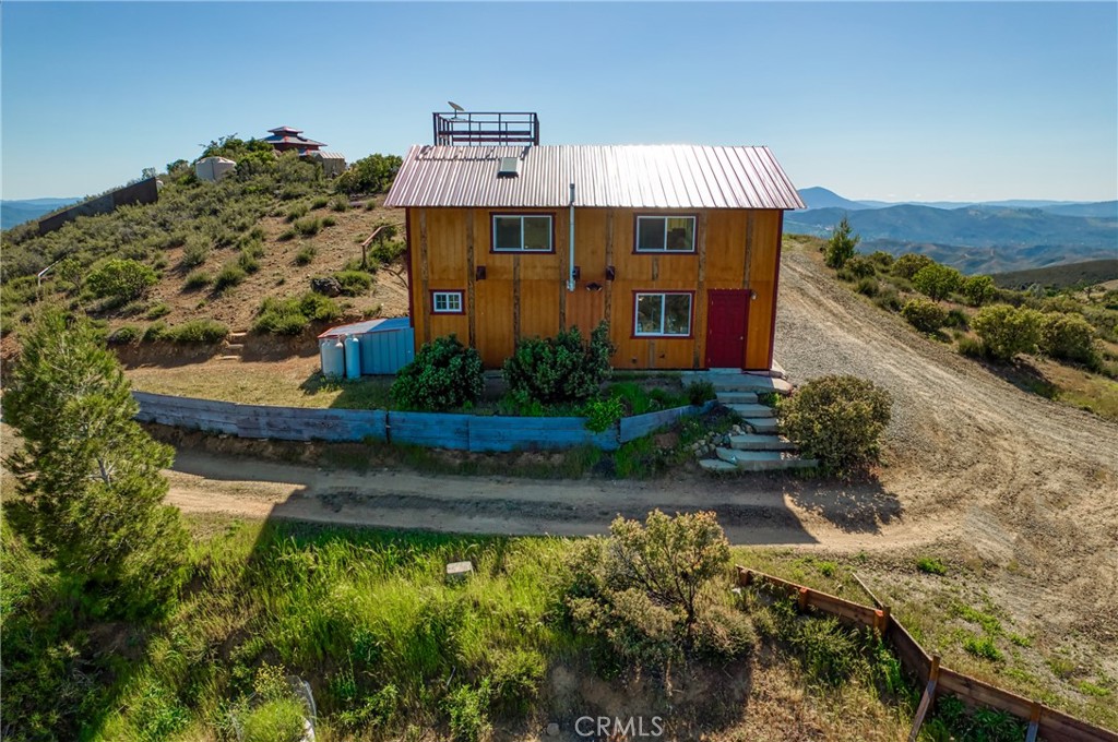 864 Watertrough Road Clearlake Oaks, CA 95423 - Photo 6 of 58 a front view of a house with a yard