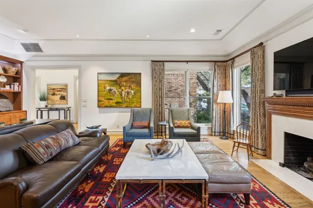 a living room with furniture a large window and a fireplace