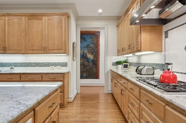 a kitchen with stainless steel appliances granite countertop a sink and cabinets