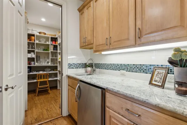a kitchen with granite countertop a sink and a stove