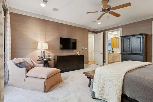 a spacious bedroom with a bed and a flat screen television