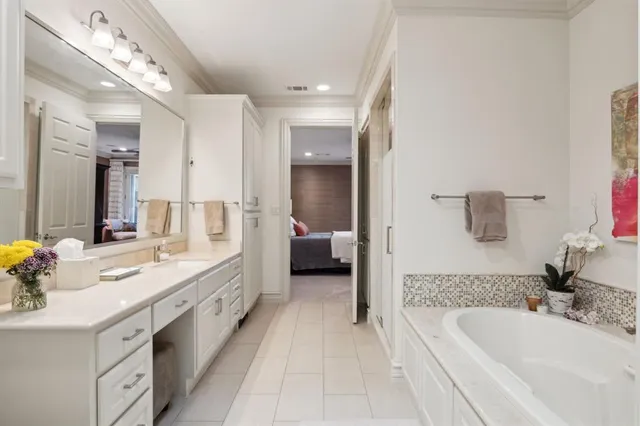 a en suite bathroom with a double vanity sink double mirror and bathtub