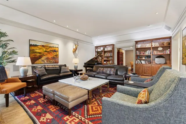 a living room with furniture a rug and a large window