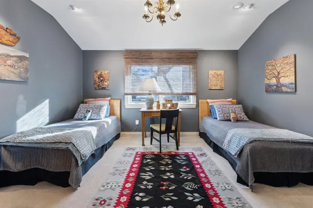 a bed room with a bed and a chandelier