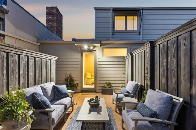 a balcony with furniture and a potted plant