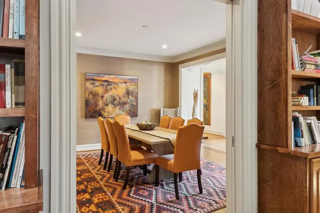 a dining room with furniture and a floor to ceiling window