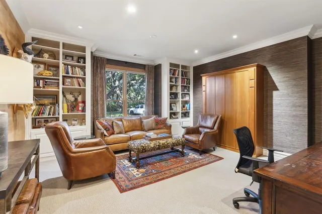 a living room with furniture and floor to ceiling window
