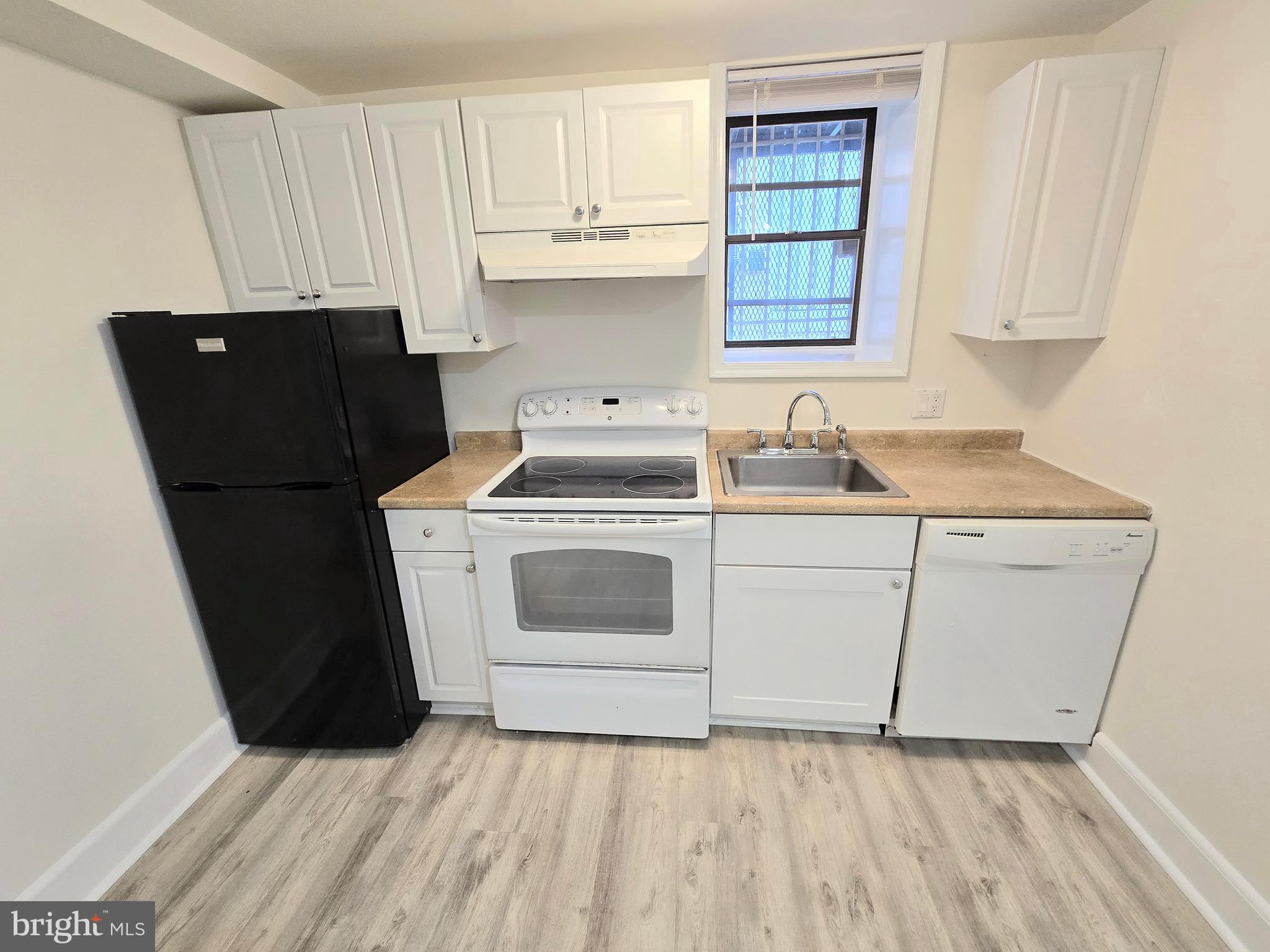 1822 15th Street Northwest, Unit B5 Washington, DC 20009 - Photo 3 of 7 a kitchen with a cabinets and white appliances