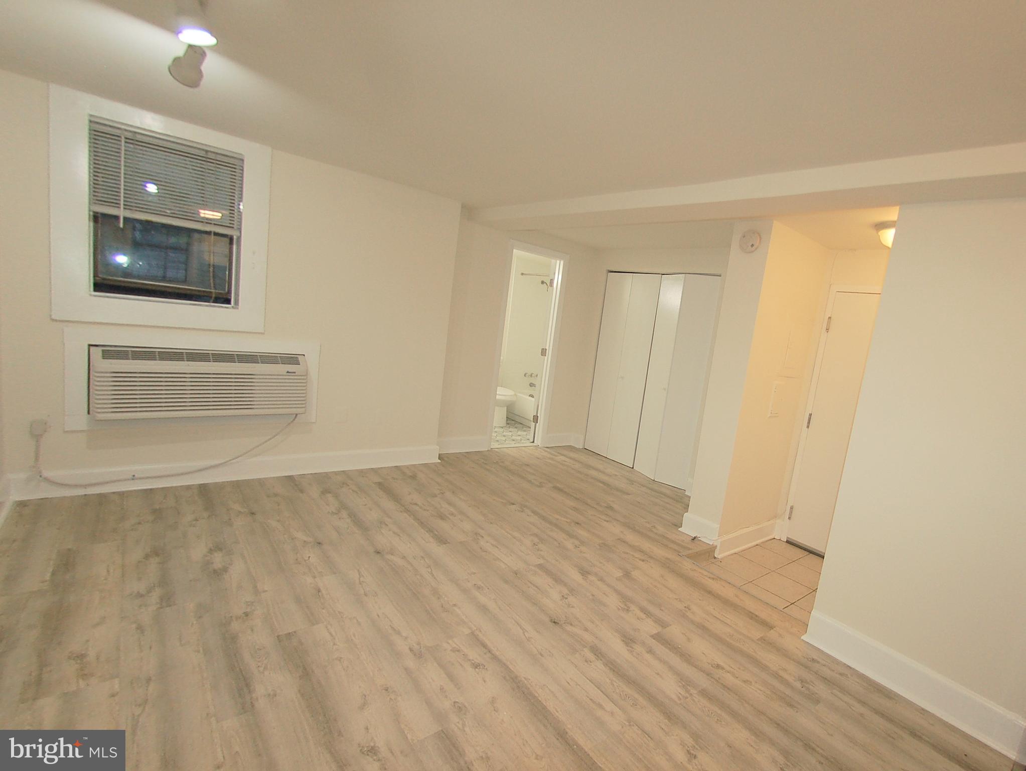 1822 15th Street Northwest, Unit B5 Washington, DC 20009 - Photo 5 of 7 a view of an empty room with wooden floor and a window