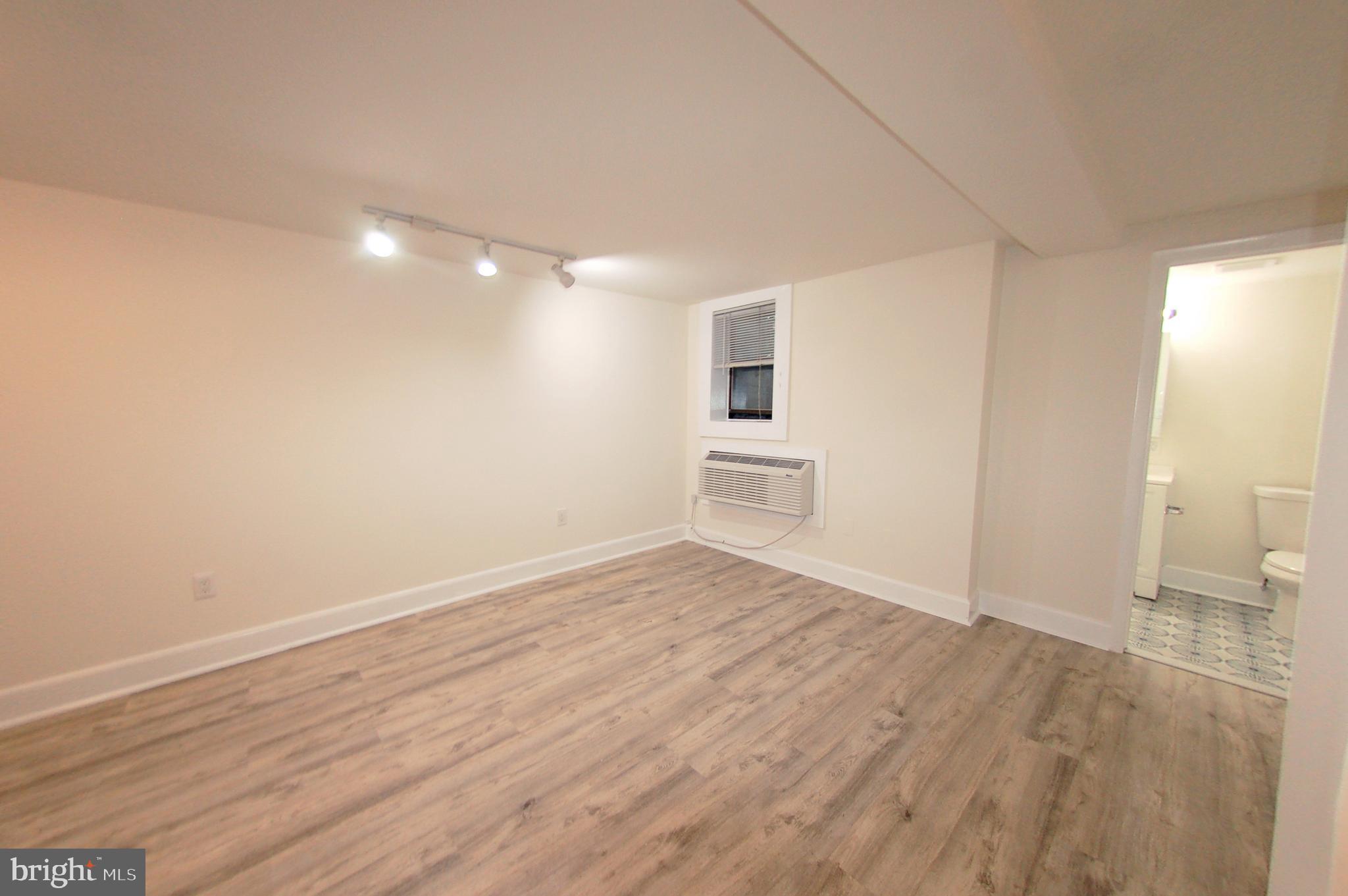 1822 15th Street Northwest, Unit B5 Washington, DC 20009 - Photo 6 of 7 wooden floor in an empty room with a window