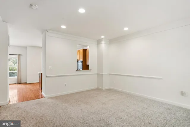 a view of kitchen with microwave a stove and wooden floors