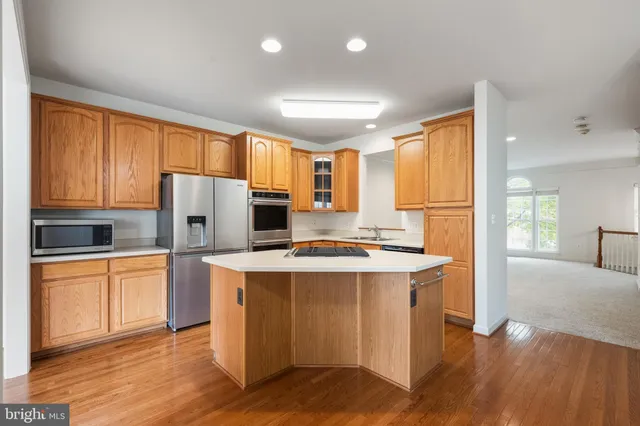 a kitchen with stainless steel appliances a refrigerator and a stove top oven