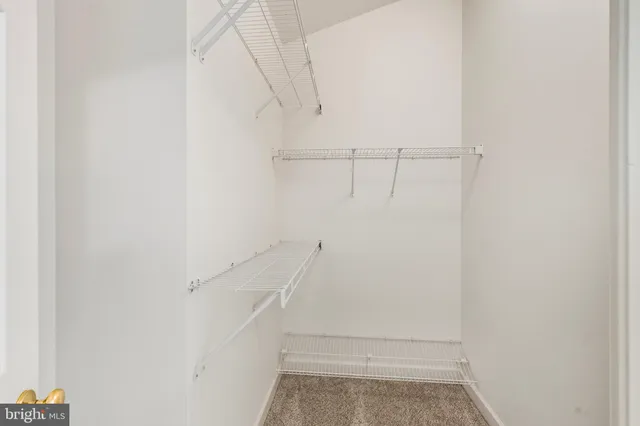 a bathroom with a double vanity sink a large mirror and a bathtub