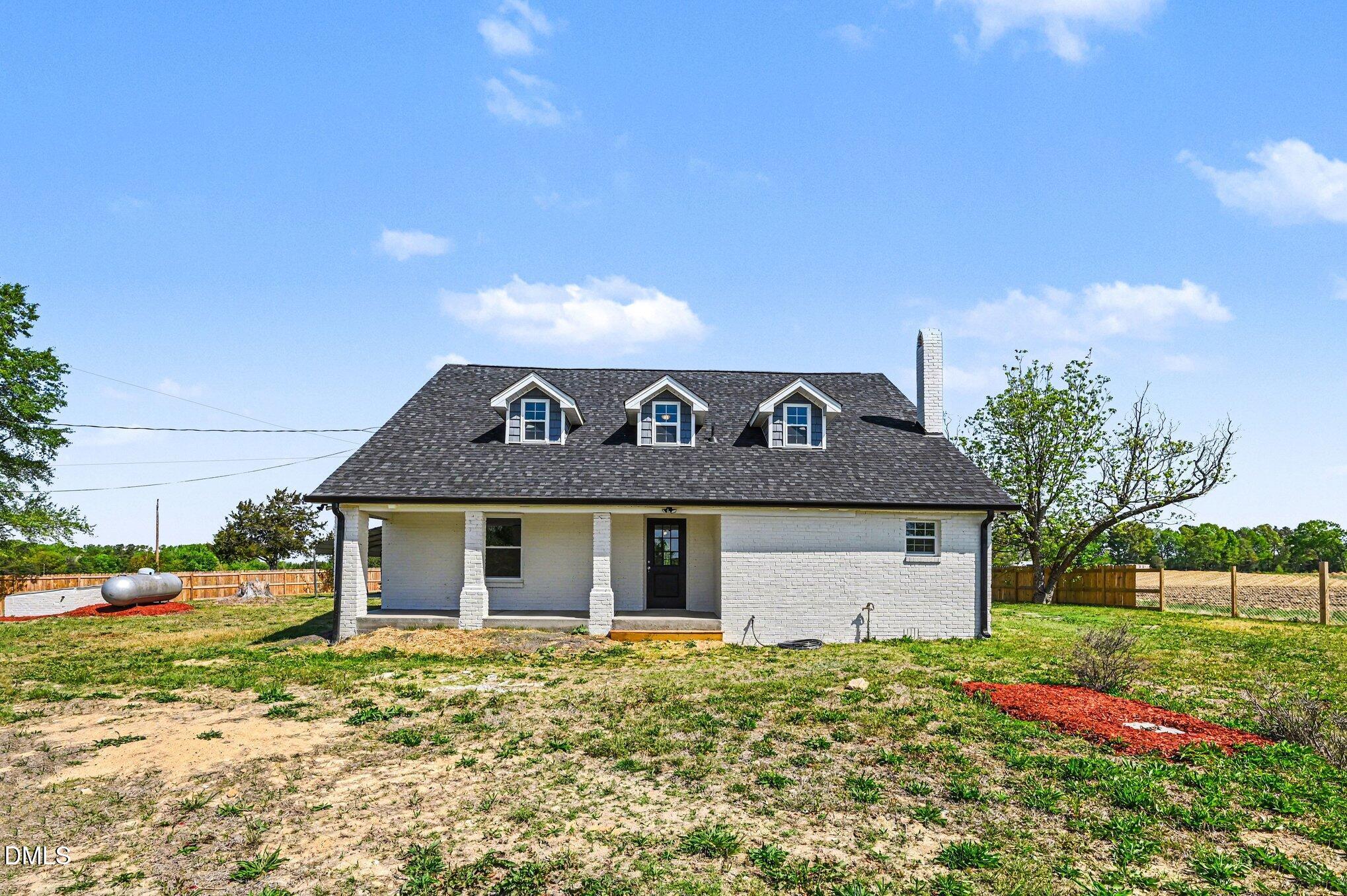 1325 Charlie Carr Road Roxboro, NC 27574 - Photo 6 of 31 a front view of a house with a garden