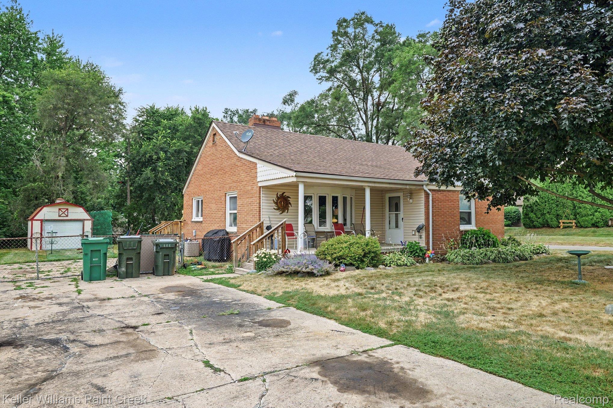 2340 Hessel Avenue Rochester, MI 48307 - Photo 24 of 25 Brick and siding exterior featuring a covered front porch with white pillars