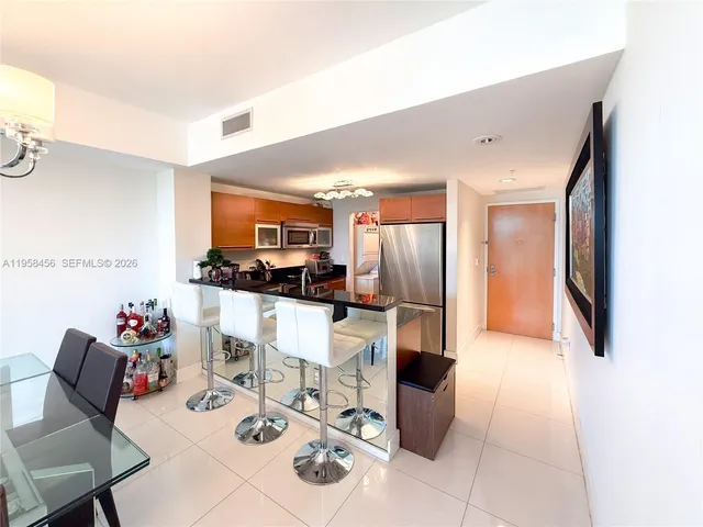 a living room with furniture a dining table and kitchen view