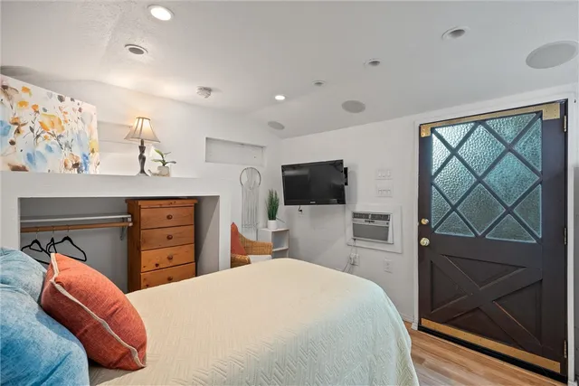 a bedroom with a bed and a television