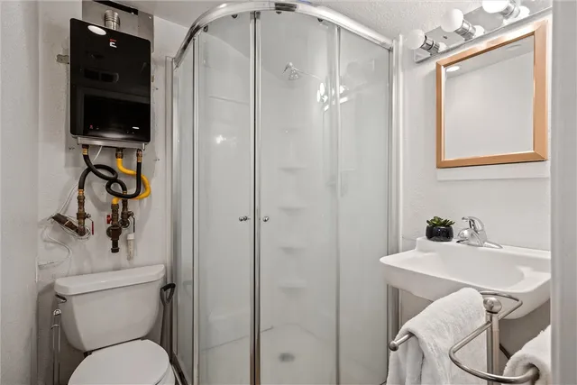 a bathroom with a toilet a sink and a mirror