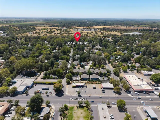 an aerial view of residential building with an outdoor space and seating