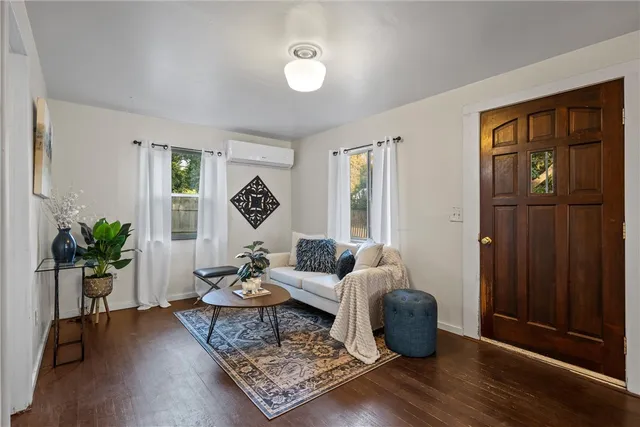 a living room with furniture rug and window
