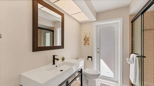 a bedroom with a bed and a painting on the wall