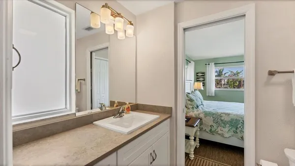 a bedroom with two beds and a large window