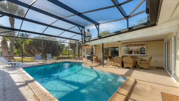 a view of a swimming pool with sitting area