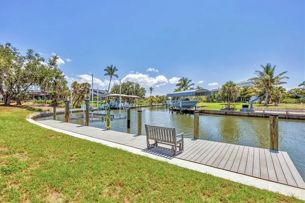 a view of a lake with a table and chairs