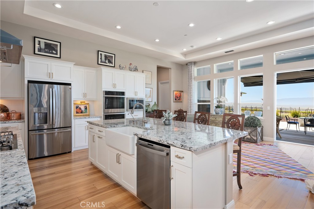 1650 Eucalyptus Road Nipomo, CA 93444 - Photo 13 of 60 a large kitchen with stainless steel appliances granite countertop a lot of counter space and wooden floor
