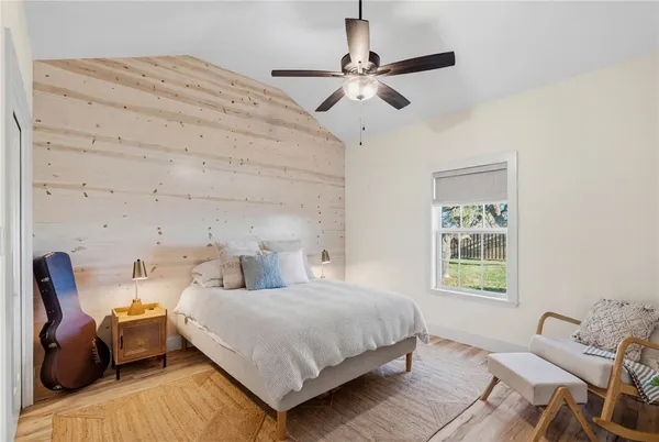 a bedroom with a bed and a window