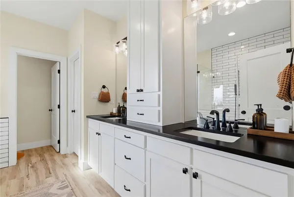 a bathroom with a sink double vanity and mirror