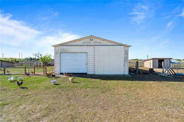 a backyard of a house with basket ball court