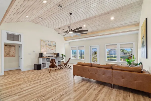 a living room with furniture and a wooden floor