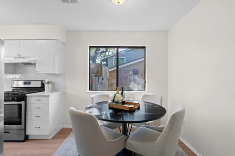 a kitchen with a table and chairs in it