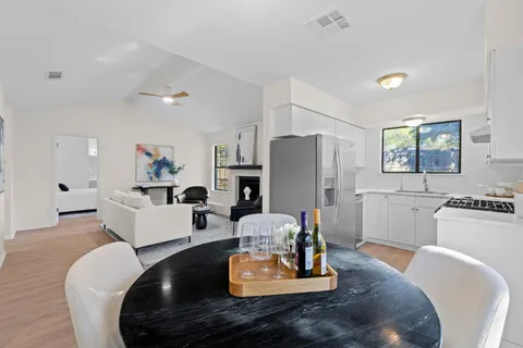 a living room with furniture fireplace and wooden floor