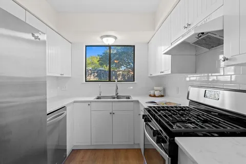 a kitchen with a sink stove and cabinets