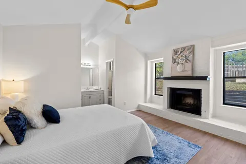 a bedroom with a bed and a fireplace