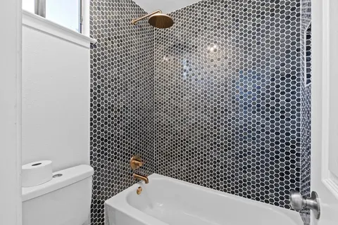 a bathroom with a bathtub and shower